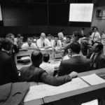In this April 16, 1970 photo made available by NASA, flight controllers gather in Mission Control in Houston during the last 24 hours of Apollo 13 mission. (NASA via AP)