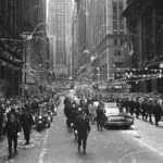 FILE - In this May 1, 1970 file photo, confetti falls from the skyscrapers in Chicago's financial district as Apollo 13 astronauts John Swigert and Jim Lovell ride in a motorcade during a parade in their honor. (AP Photo)