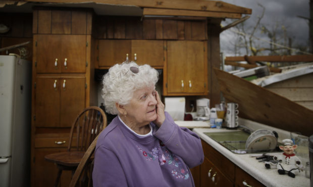 Emma Pritchett wipes a tear away in her roofless kitchen the day after a tornado hit, Monday, April...