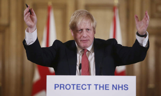 FILE - In this Sunday March 22, 2020 file photo British Prime Minister Boris Johnson gestures durin...