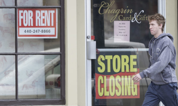 FILE A man walks past a closed business, Wednesday, April 29, 2020, in Chagrin Falls, Ohio. (AP Pho...