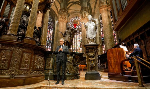Italian singer Andrea Bocelli, left, performs inside an empty Duomo cathedral, on Easter Sunday, in...