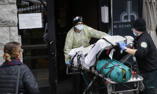 FILE- In this April 17, 2020, file photo, a patient is wheeled into Cobble Hill Health Center by em...
