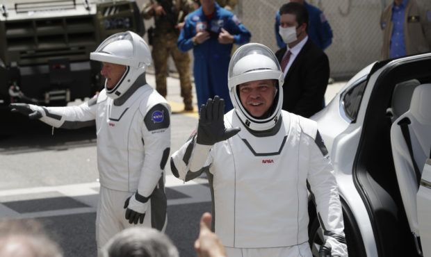 2 astronauts climb aboard SpaceX rocket for historic flight...