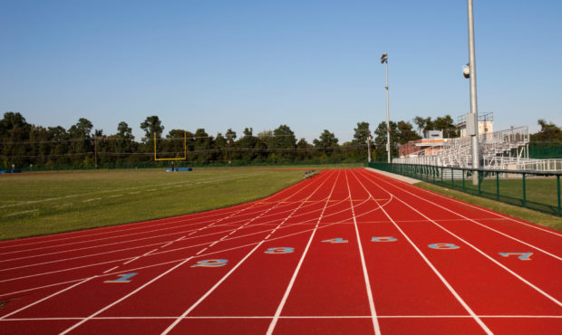 A newly built track and football field venue at a high schools stadium shot in the USA using a Cano...