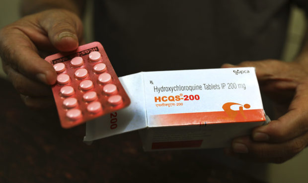 FILE - In this April 9, 2020 file photo, a chemist displays hydroxychloroquine tablets in New Delhi...