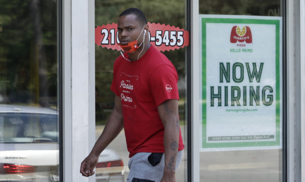 A man walks past Marco's Pizza, which is now hiring, Friday, June 5, 2020, in Euclid, Ohio. U.S. un...