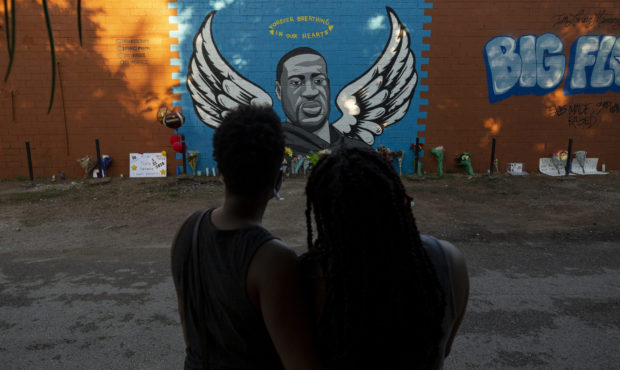 LaQuincia Pittman, left, and her wife Kaysi Higgins look at the George Floyd mural in Third Ward on...