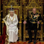 FILE - In this Wednesday, May 9, 2012 file photo, Britain's Queen Elizabeth II sits next to Prince Philip in the House of Lords as she waits to read the Queen's Speech to lawmakers in London. (AP Photo/Alastair Grant, File)