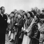 FILE - In this March 10, 1957 file photo, Britain's Prince Philip is greeted by some of the students of St. Mary's College, in Cheltenham, England, as he left the playing fields of St. Paul's College  (AP Photo/File)