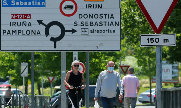People cross the border between France and Spain at Behobie, southwestern France, Sunday, June 21, ...