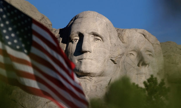 FILE - In this Sept. 11, 2002, file photo, the sun rises on Mt. Rushmore National Memorial near Key...