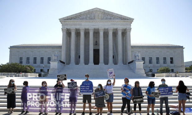 Anti-abortion protesters wait outside the Supreme Court for a decision, Monday, June 29, 2020 in Wa...