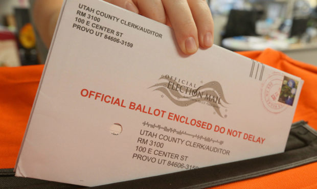 Image of a person voting by mail in Utah. After a Utah lawmaker suggested that voters should have t...
