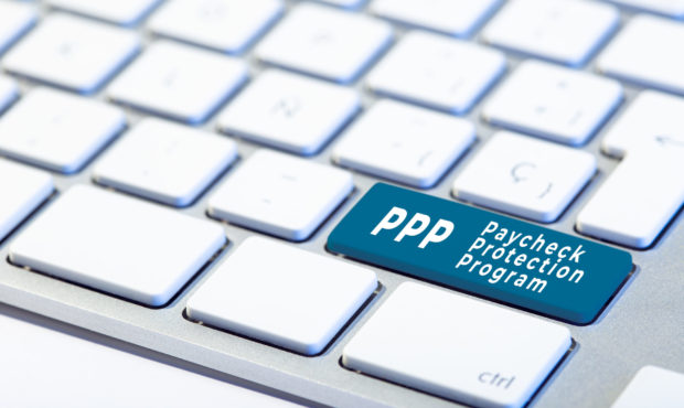 PPP Paycheck Protection Program concept. Inscription on Keyboard Key and hand with protective glove...