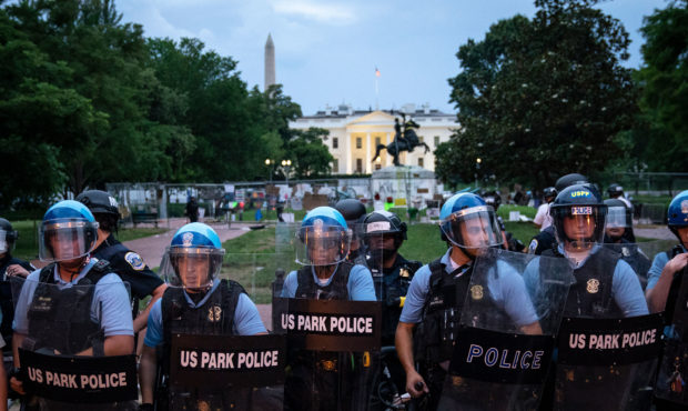 WASHINGTON, DC - JUNE 22:  U.S. Park Police keep protesters back after they attempted to pull down ...