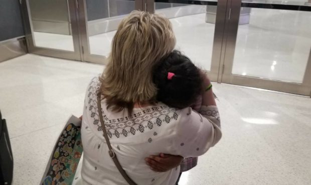 Laurie Holt embraces Nathalia, daughter of Thamy and stepdaughter of her son Josh, as she arrives i...
