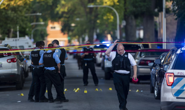 Chicago police officers investigate the scene of a deadly shooting in Chicago on July 5, 2020, wher...