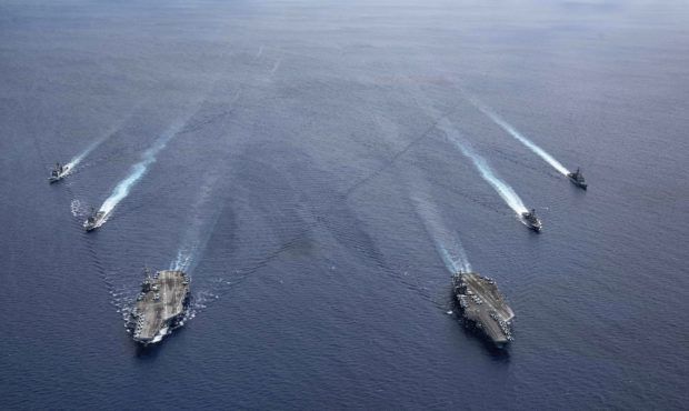 In this photo provided by U.S. Navy, the USS Ronald Reagan (CVN 76) and USS Nimitz (CVN 68) Carrier...