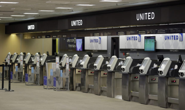 FILE - In this April 24, 2020 file photo, empty United Airlines ticket machines are shown at the Ta...