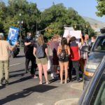 Protesters surround a TV photographer, preventing him from filming them outside the office of Salt Lake County District Attorney Sim Gill on July 9, 2020. Photo: Paul Nelson, KSL NewsRadio 
