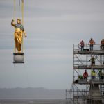 The angel Moroni and capstone being removed by a large crane with artisan journeyman viewing in the background as part of the ongoing renovation of the Salt Lake Temple, May 18, 2020.

 Intellectual Reserve
