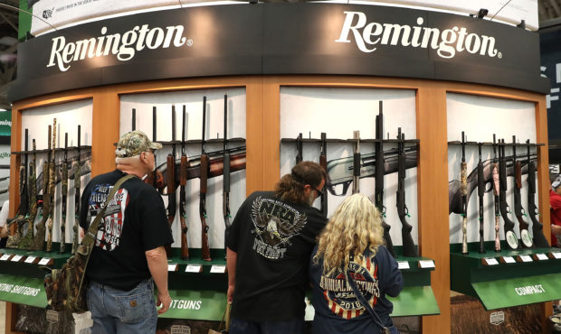 DALLAS, TX - MAY 05:  Attendees look at a display of Remington shotguns during the NRA Annual Meeti...