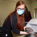 Emiline Twitchell, conservator at the Church History Library, removes time capsule items from the capstone of the Salt Lake Temple | Intellectual Reserve 