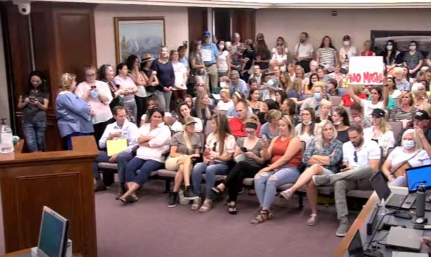(The audience attending the Utah County Commission meeting July 15, 2020.  Chair Tanner Ainge ended...