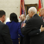 Joshua Holt, center, who was recently released from a prison in Venezuela, smiles with Rep. Mia Love, R-Utah, left, with his mother Laurie Holt, far left, and Sen. Mike Lee, R-Utah, second from left, as Sen. Bob Corker, R-Tenn., hugs Sen. Orrin Hatch, R-Utah, with President Donald Trump at right, in the Oval Office of the White House, Saturday, May 26, 2018, in Washington. (AP Photo/Alex Brandon)