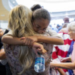FILE: Thamy Holt's daughter, Marian, center right, is hugged by her aunt, Jenna Nemeth, at Salt Lake City International Airport, Monday, May 28, 2018, in Salt Lake City. Marian arrived with her parents, Josh and Thamy Holt, who were released from a Venezuelan jail on May 26, 2018 after nearly two years. (AP Photo/Kim Raff)