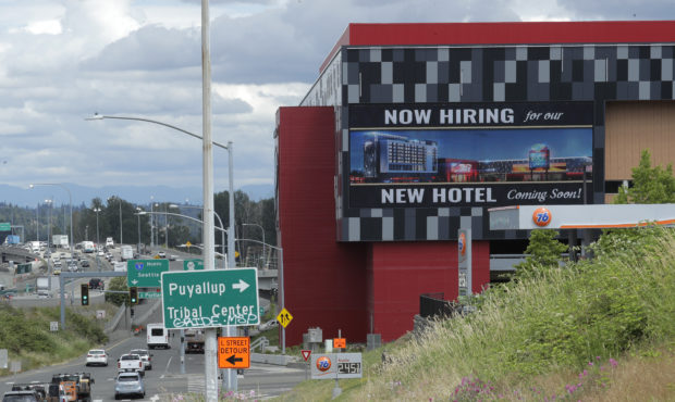 FILE - In this July 9, 2020, file photo, a large video display reads "Now hiring for our new hotel ...