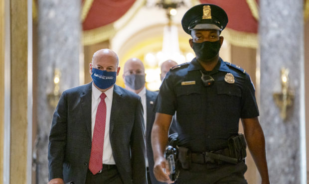 FILE - In this Aug. 5, 2020, file photo Postmaster General Louis DeJoy, left, is escorted to House ...