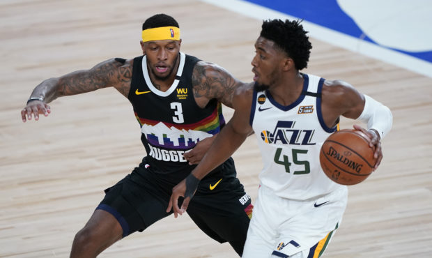 Utah Jazz's Donovan Mitchell (45) looks to pass as Denver Nuggets' Torrey Craig (3) defends during ...