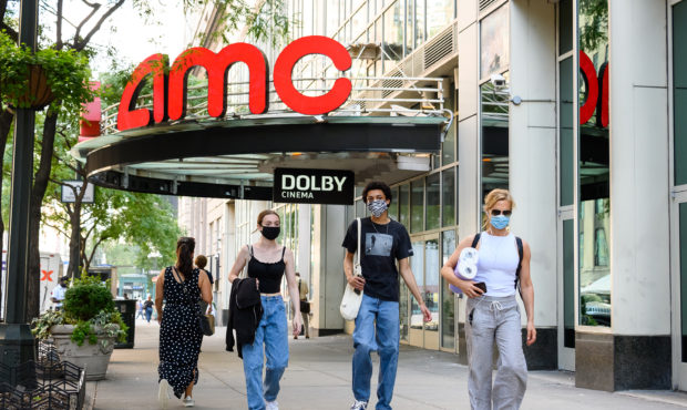 NEW YORK, NEW YORK - JULY 31: People wear protective face masks outside the AMC 34th Street 14 movi...