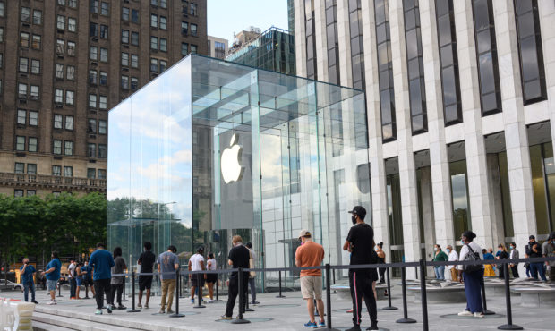 NEW YORK, NEW YORK - JUNE 30: People stand in line outside the Apple store on Fifth Avenue as New Y...