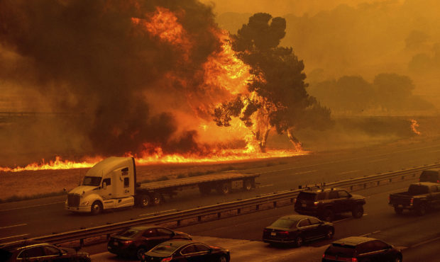 Flames from the LNU Lightning Complex fires jump Interstate 80 in Vacaville, Calif., Wednesday, Aug...
