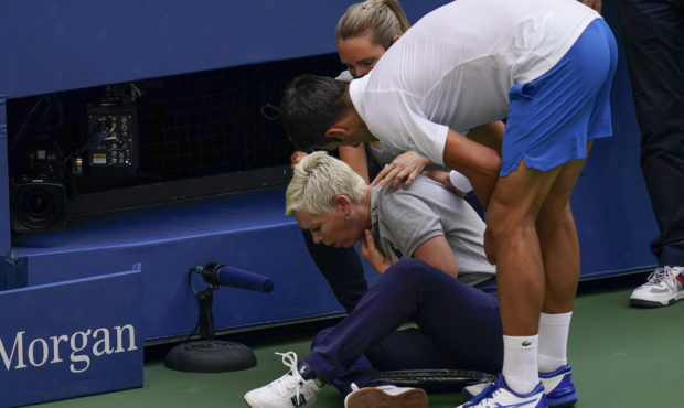 Novak Djokovic, of Serbia, checks a linesman after hitting her with a ball in reaction to losing a ...