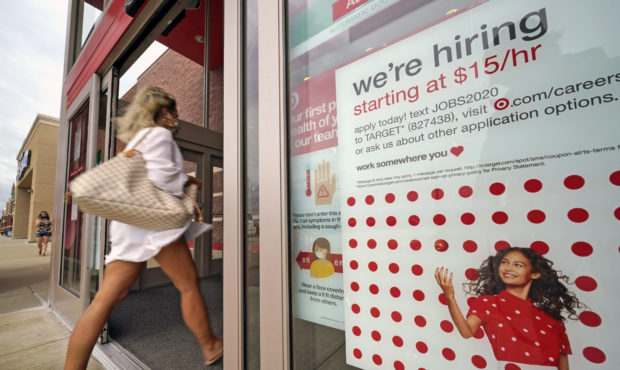 FILE - In this Sept. 2, 2020, file photo, a help wanted sign hangs on the door of a Target store in...