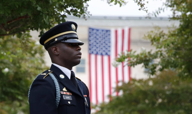 FILE - In this Sept. 11, 2019, file photo, a member of the U.S. Army Old Guard stands on the ground...