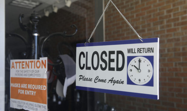 FILE - In this July 18, 2020 file photo a closed sign hangs in the window of a barber shop in Burba...