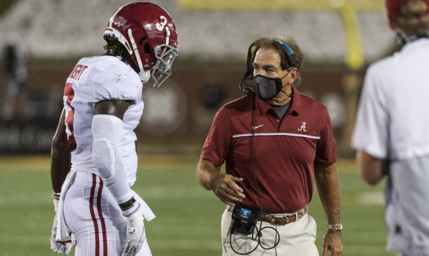 Alabama head coach Nick Saban, right, talks with Daniel Wright as he walks off the field during the...