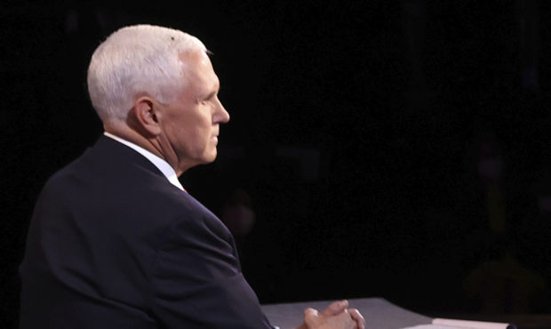 A fly lands on the head of Vice President Mike Pence during the vice presidential debate Wednesday,...