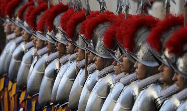 FILE - In this Oct. 4, 2020 file photo, Vatican Swiss Guards stand attention at the St. Damaso cour...