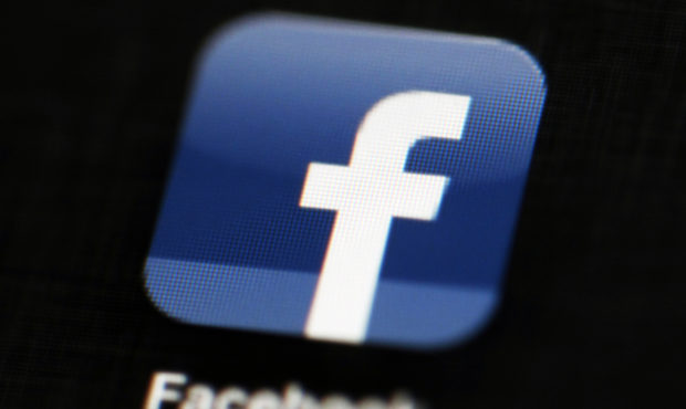 FILE - This May 16, 2012 file photo shows the Facebook app logo on a mobile device in Philadelphia....