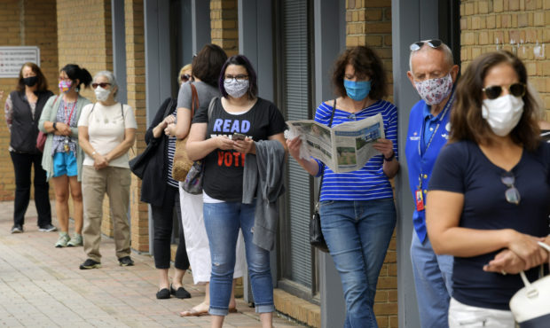 FILE - In this Sept. 18, 2020 file photo, Alexandria residents wait in a socially distance line to ...