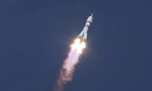 In this image made from video footage released by Roscosmos Space Agency, the Soyuz-2.1a rocket boo...