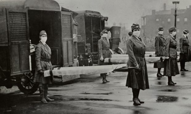 The St. Louis Red Cross Motor Corps was on duty with mask-wearing women holding stretchers at the b...