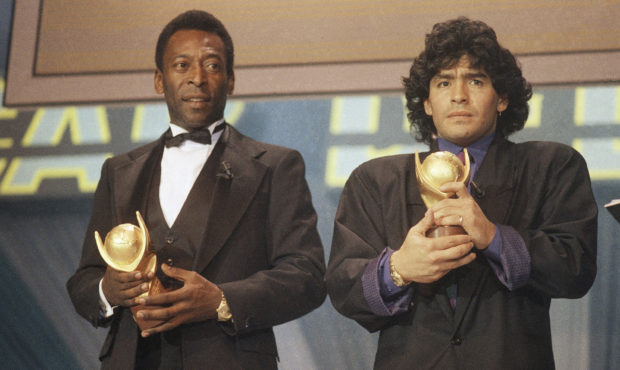 FILE - In this March 1987 file photo, Pele, left, and Maradona hold "Sports Oscar" trophies in Mila...