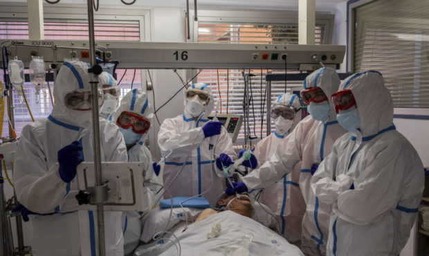 FILE - In this Friday, Oct. 9, 2020 photo, a patient infected with COVID-19 is treated in one of th...